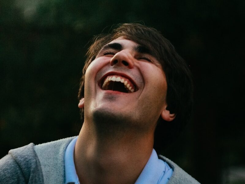 man in gray sweater smiling