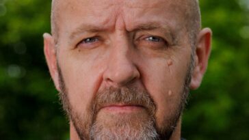 a close up of a person wearing a black shirt