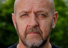 a close up of a person wearing a black shirt