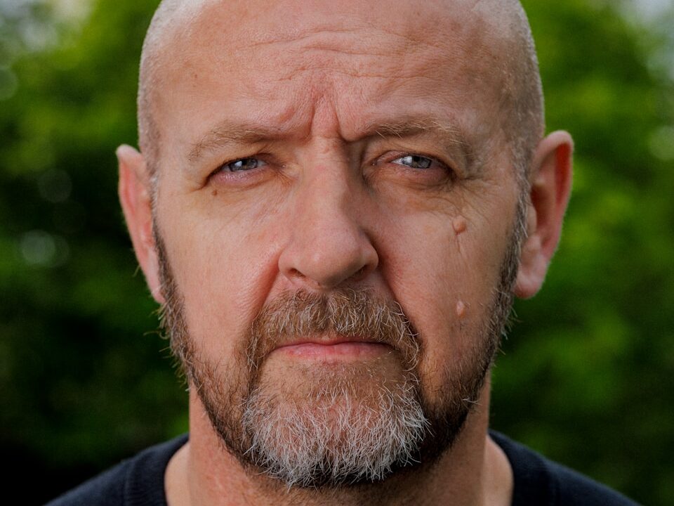 a close up of a person wearing a black shirt