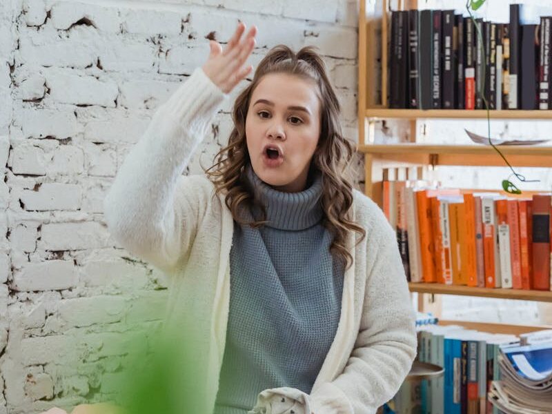 Annoyed woman emotionally shouting at husband and proving opinion to partner while man browsing laptop and ignoring
