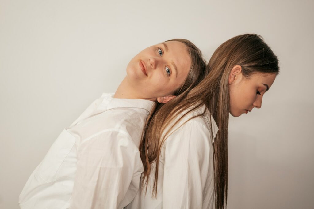 woman in white long sleeve shirt beside woman in white shirt