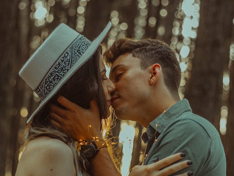 man kissing woman