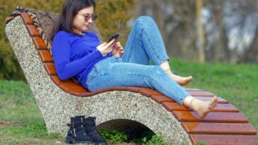 woman, young, nature, sitting, bench, park, looking, smartphone, relaxation, sunglasses, jeans, lifestyle, spring