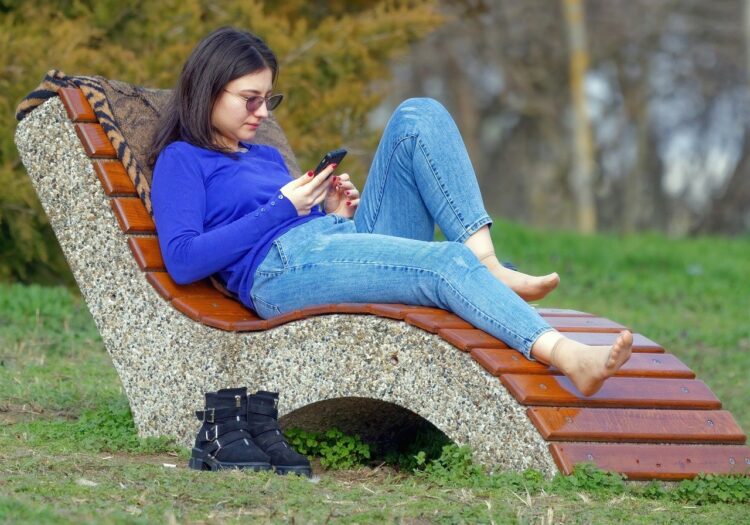 woman, young, nature, sitting, bench, park, looking, smartphone, relaxation, sunglasses, jeans, lifestyle, spring