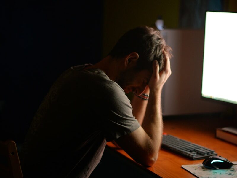 a man sitting at a desk in front of a computer