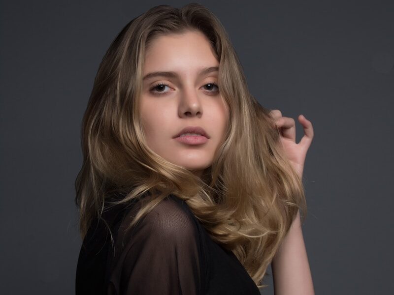 woman holding heft long blonde hair