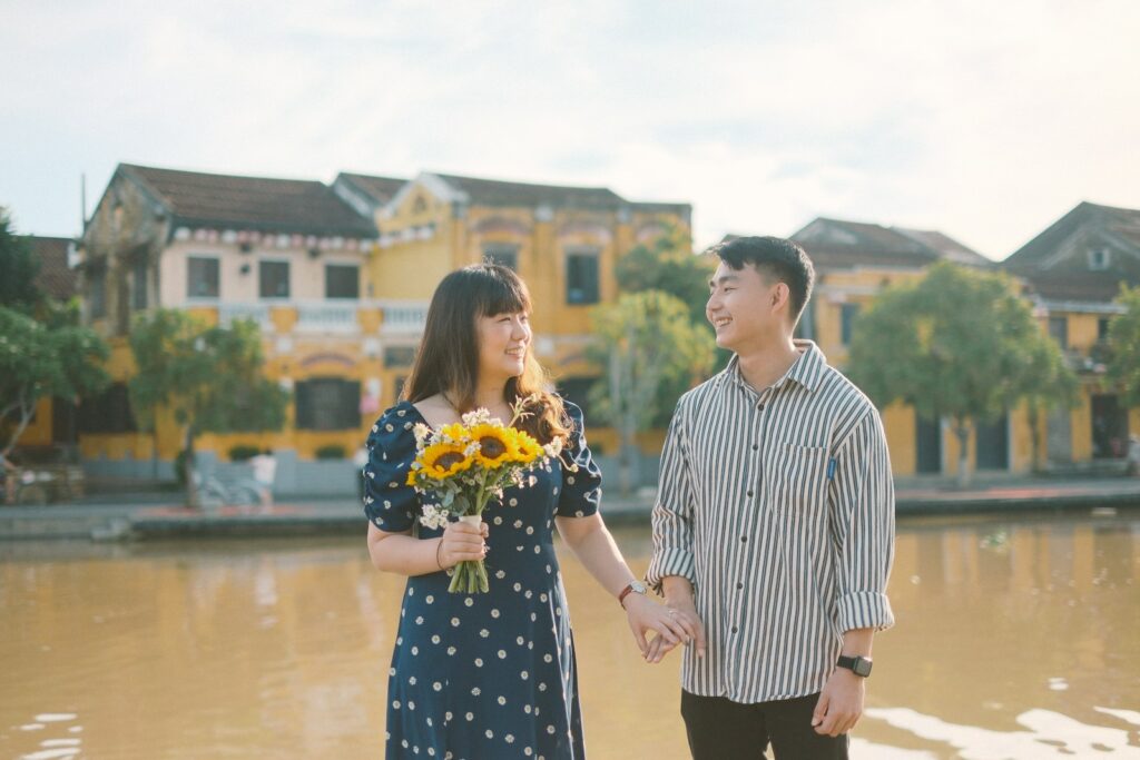 Couple holding hands and looking lovingly at each other.