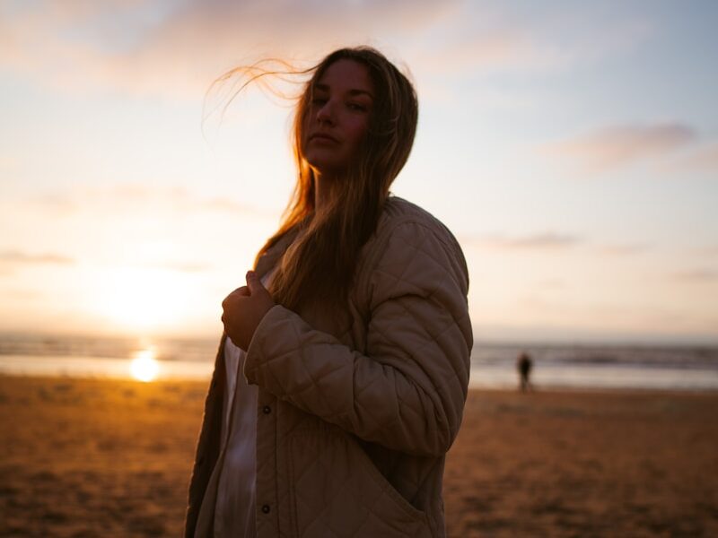 Woman on a beach at sunset.