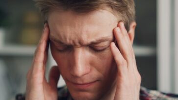 a man holding his hands to his ears