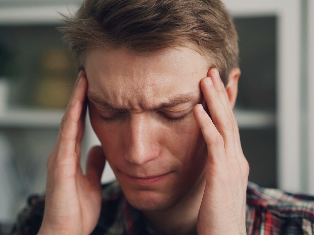 a man holding his hands to his ears