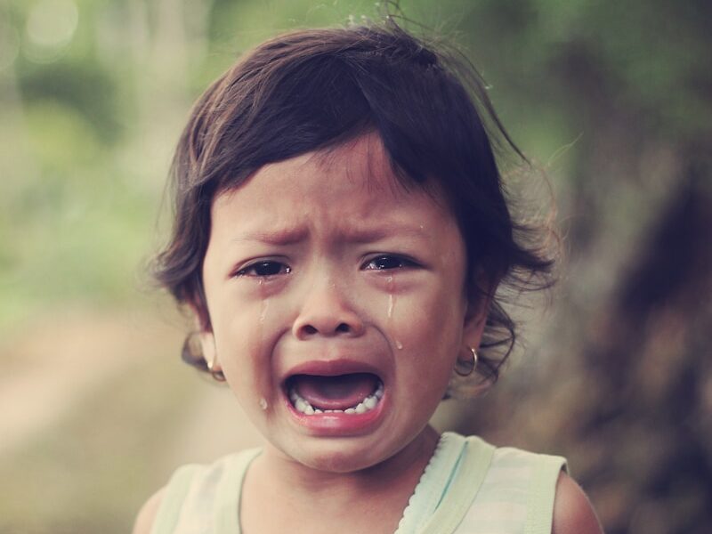 selective focus photography of girl crying