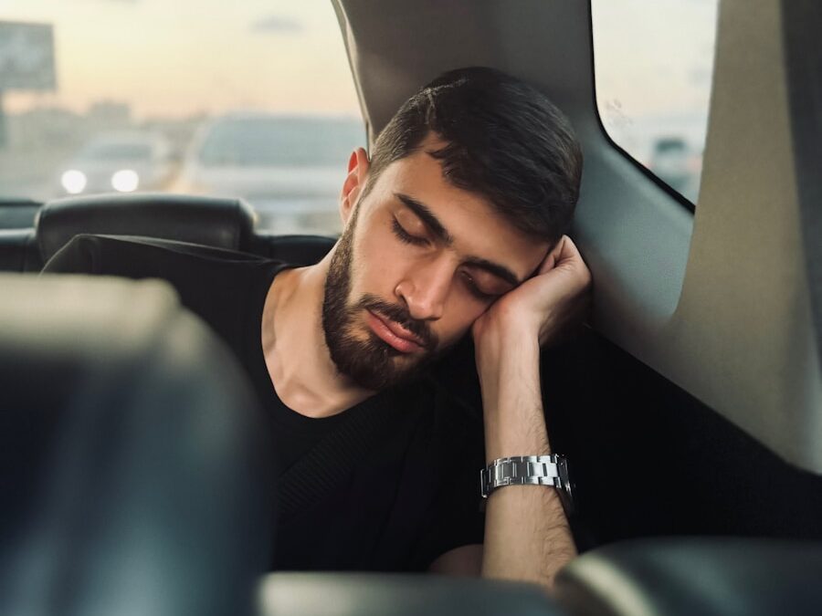 A man sitting in the back seat of a car