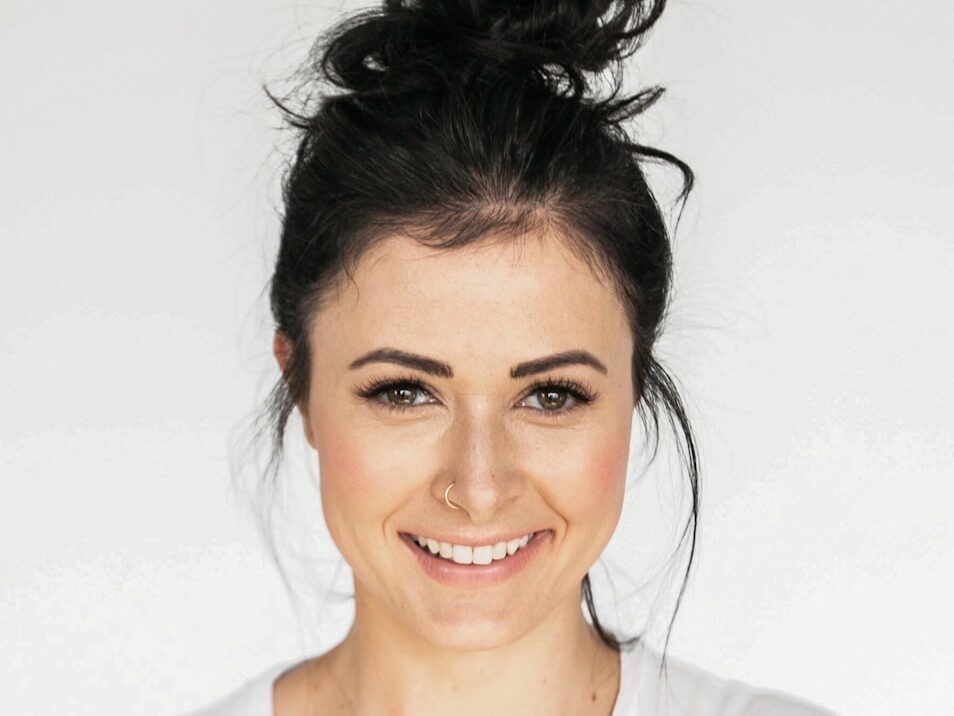woman in white crew neck shirt smiling