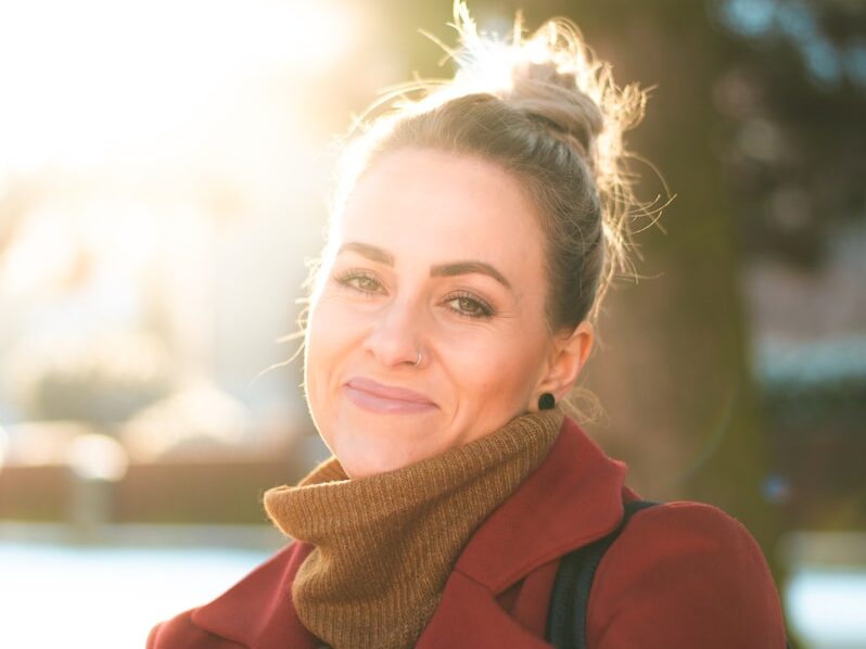 woman in red coat smiling