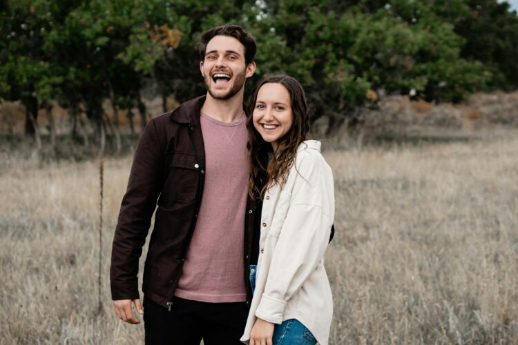 A man and a woman standing in a field