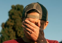 man covering his face