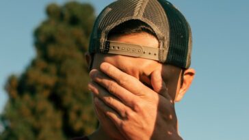 man covering his face