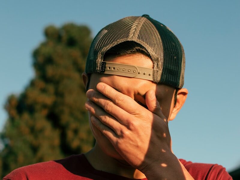 man covering his face