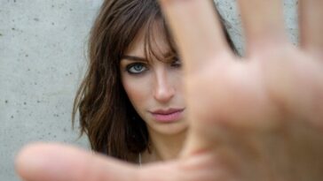 glaring woman reaching her hand