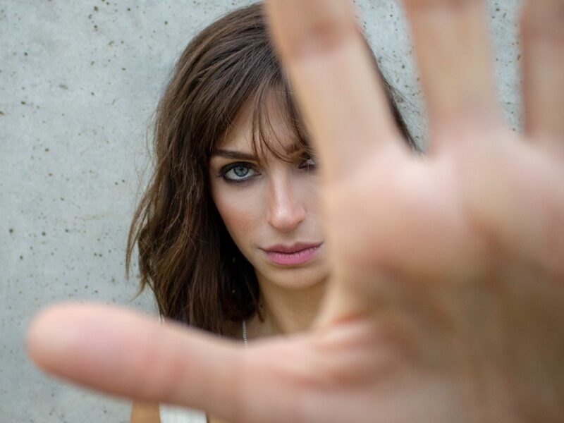 glaring woman reaching her hand