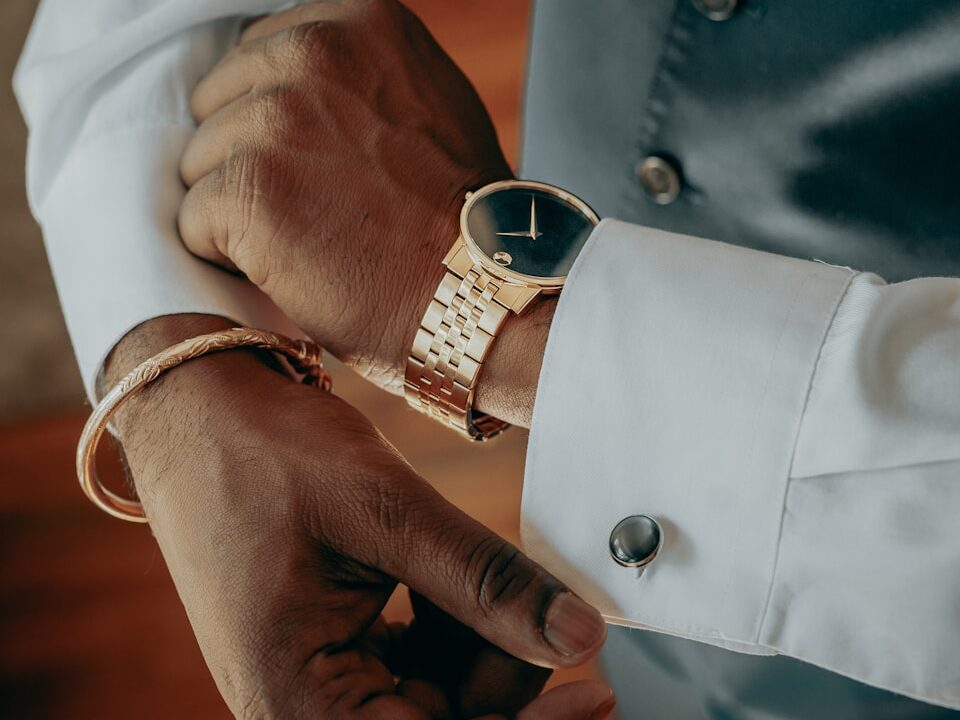a person's hands with a ring on their wrist