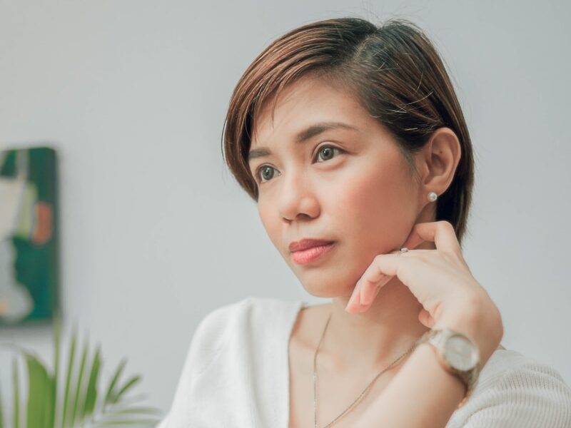 woman in white button up shirt sitting on chair