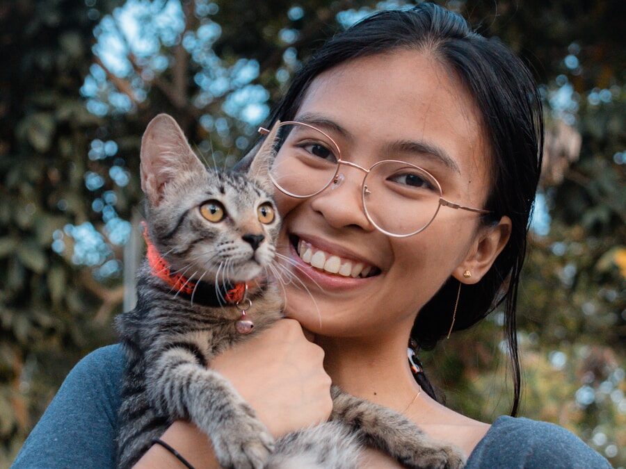a woman holding a cat in her arms