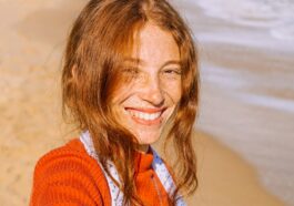woman in red knit sweater smiling