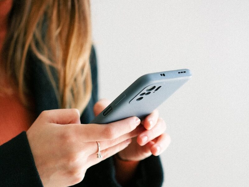 a woman holding a cell phone in her hands
