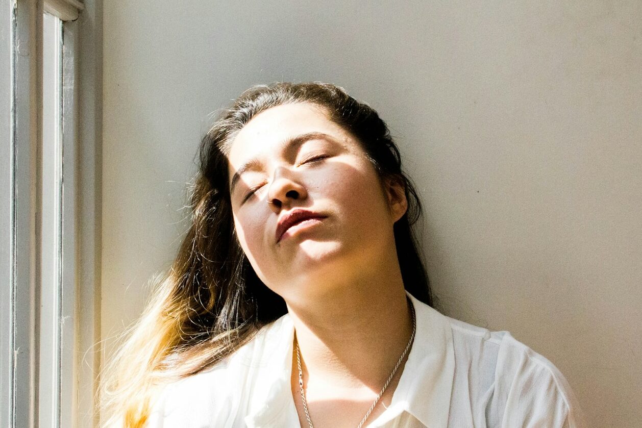 woman standing near window during daytime