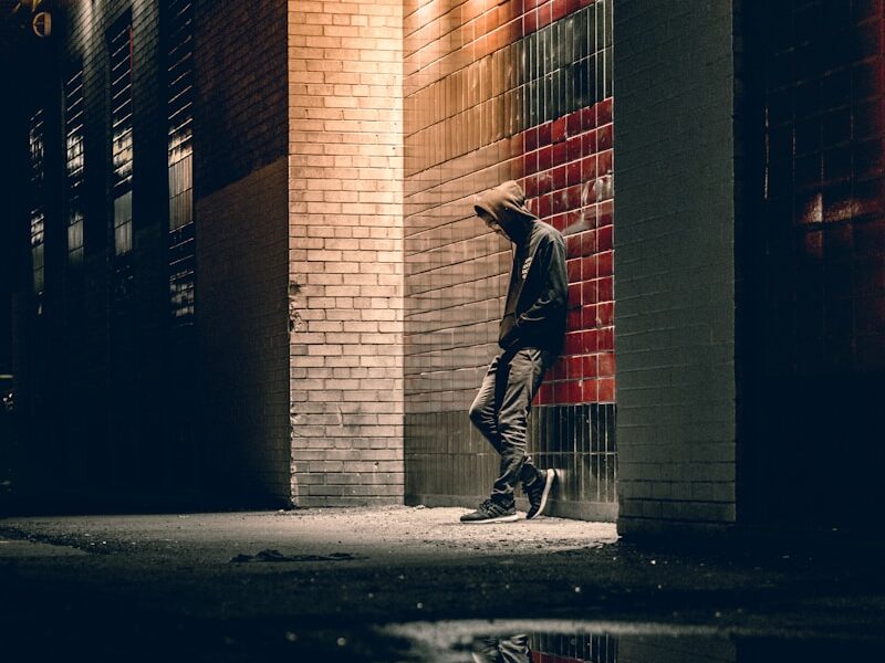 man learning on concrete wall