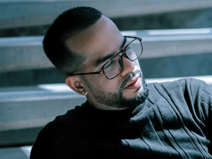 man in black crew neck shirt wearing black framed eyeglasses
