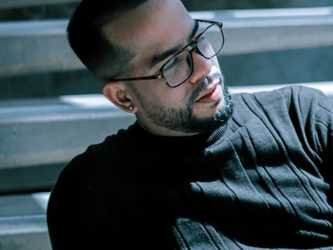 man in black crew neck shirt wearing black framed eyeglasses
