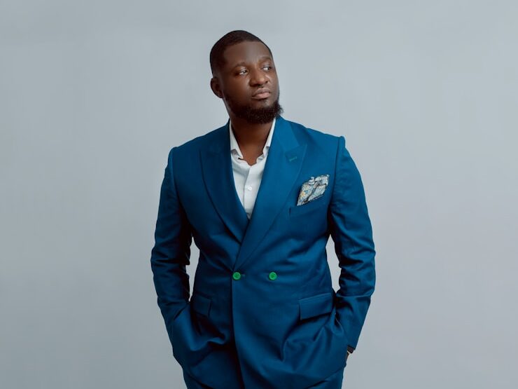 a man in a blue suit posing for a picture