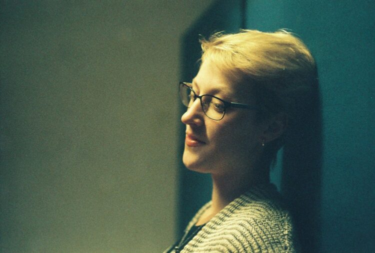 woman in black and white shirt wearing black framed eyeglasses