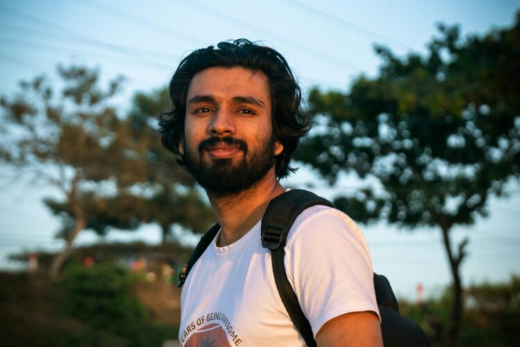 a man with a beard wearing a white shirt