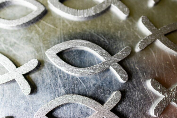 a close up of a metal plate with a cross and a symbol on it