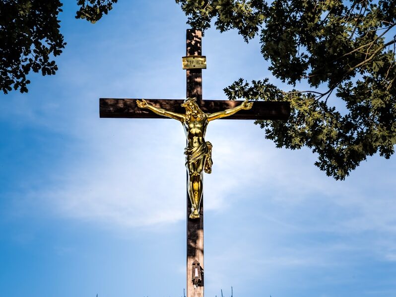 a cross in the middle of a corn field