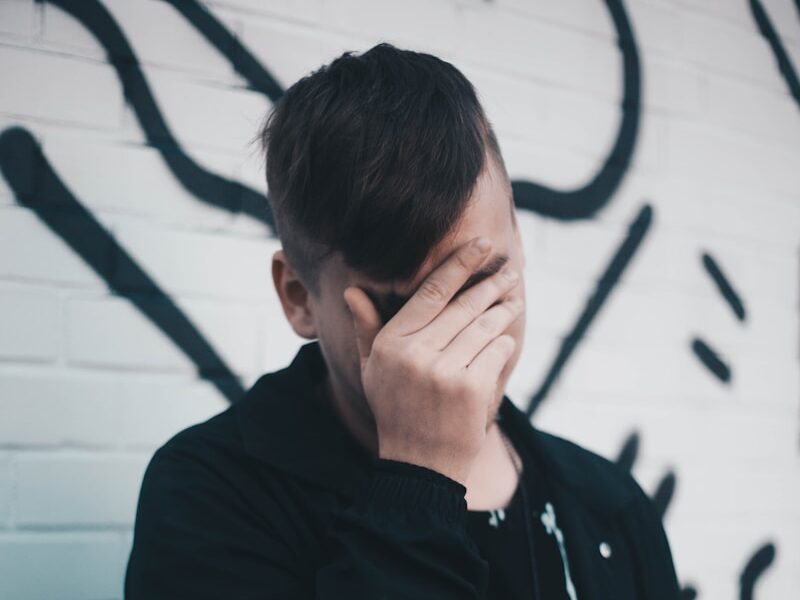 man touching his forehead