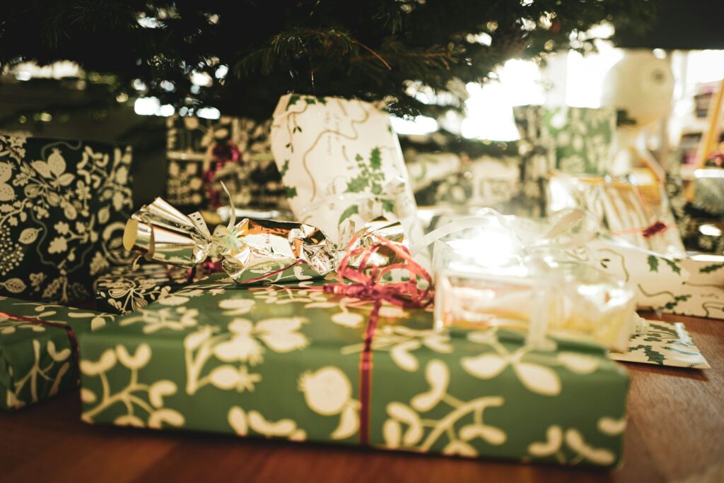 a group of wrapped presents under a christmas tree