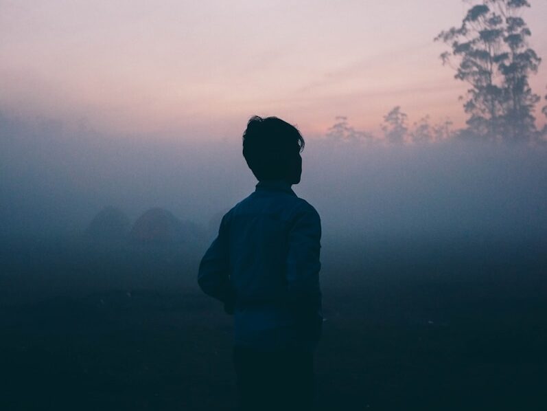 a man walks alone in the haze