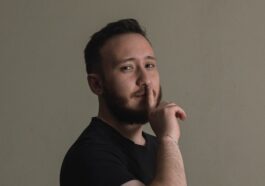a man is posing for a picture with his hand on his chin