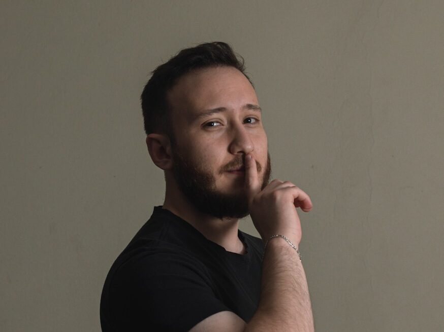 a man is posing for a picture with his hand on his chin
