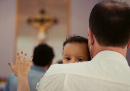 boy in white shirt raising his hands
