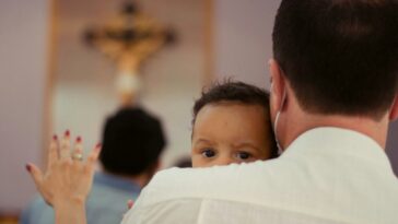 boy in white shirt raising his hands
