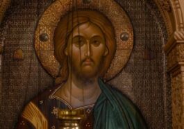 A classic Orthodox icon depicting Jesus Christ with an ornately carved frame in warm tones.