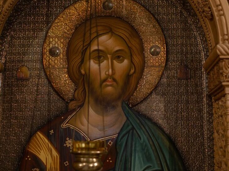 A classic Orthodox icon depicting Jesus Christ with an ornately carved frame in warm tones.
