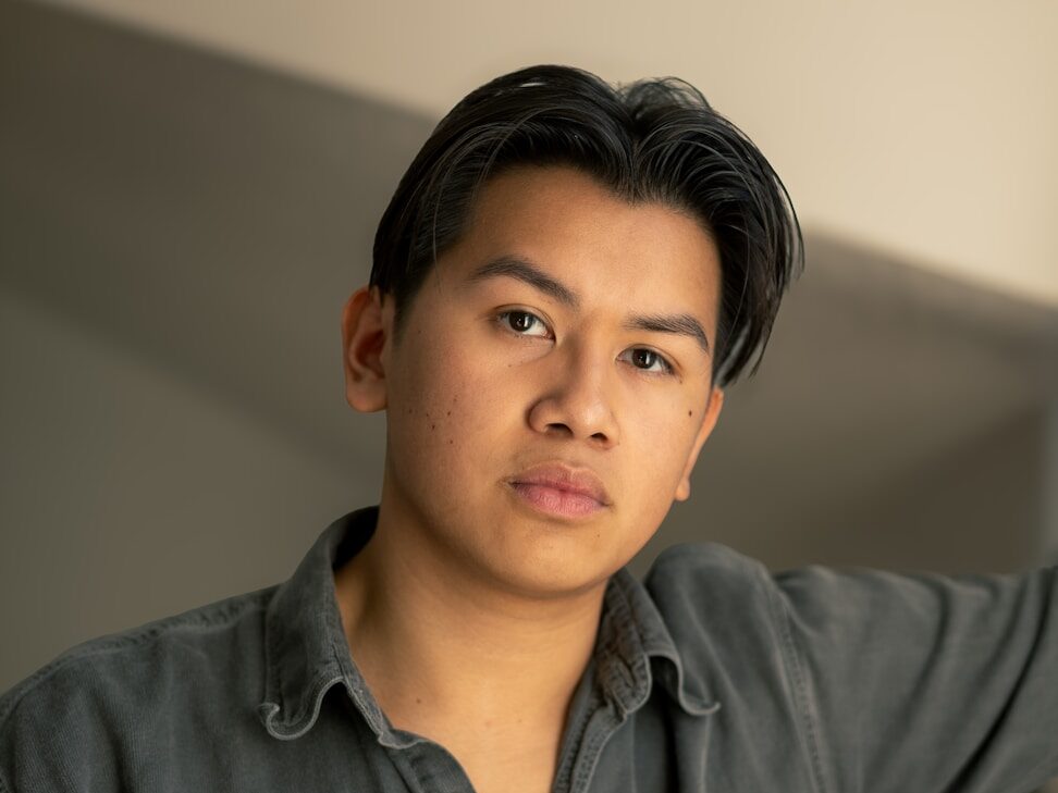 Young man in a collared shirt looking forward.