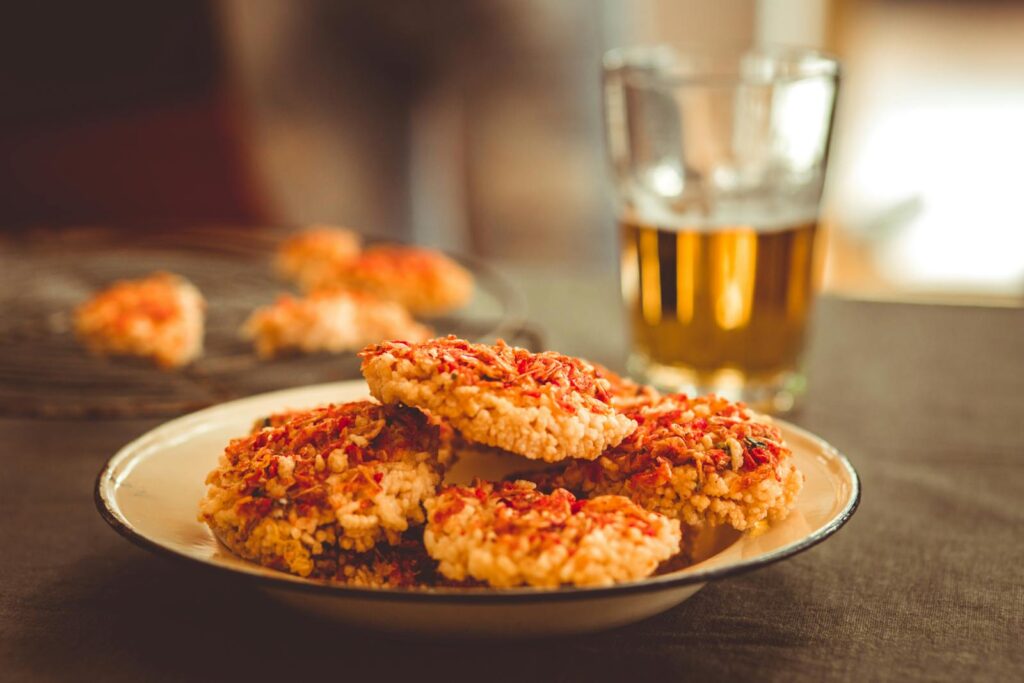 Delicious rice cakes topped with seasoning served with a cold drink, perfect for an appetizing meal.